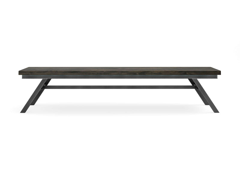 The Fulton Bench - Deep Grey by James+James is a minimalist wooden bench with a sleek, rectangular design and a dark finish. Featuring a sturdy metal frame with angled legs, it has a modern and industrial look. The bench sits on a white background, highlighting its simple and clean lines.