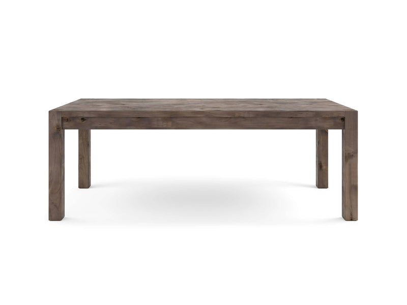 The Jonathan Dining Table - Barn Wood by James+James is a rectangular wooden table with a rustic finish. It features clean lines and a simple design with four sturdy legs. The wood has a weathered appearance, giving it a slightly aged and natural look. The backdrop is white.