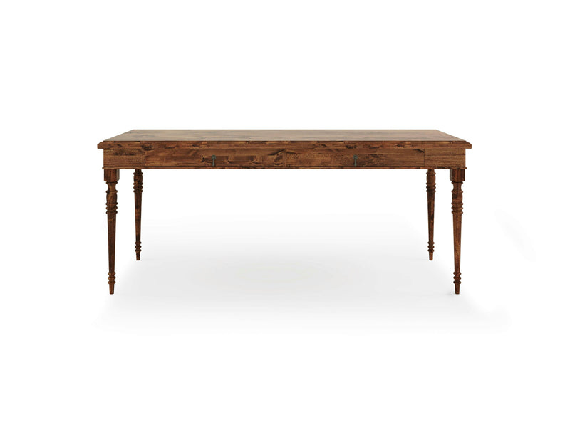 The Audrey Desk - Tuscany by James+James is a rectangular wooden piece with a rustic, natural finish. It features four intricately carved legs with spindle designs, giving it a classic and elegant look. The surface beautifully showcases the wood's natural grain, adding to its vintage charm.