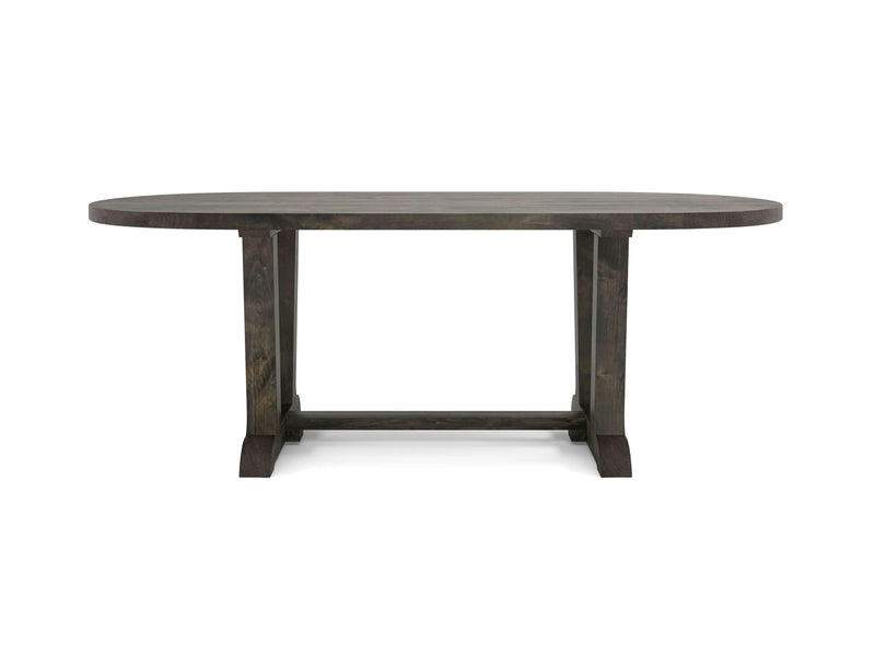 Introducing the Thaden Oval Dining Table in Deep Grey by James+James. This oval-shaped wooden dining table features a dark finish and boasts a sturdy trestle base with two legs connected by a horizontal support bar. Its simple, rustic design makes it an excellent choice for dining rooms or kitchens.