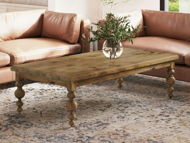 The Olivia Coffee Table - Harvest Wheat by James+James is a beautifully crafted wooden rectangular coffee table featuring a smooth surface and turned, ornate legs, elegantly displayed against a plain white background.