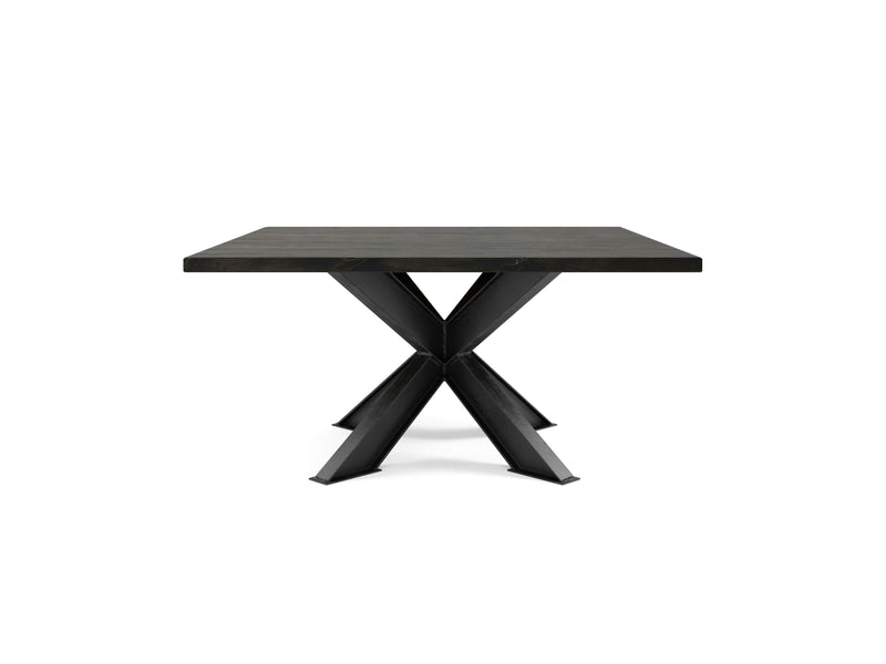 The Shiloh Square Dining Table - Charred Ember by James+James features a thick top and sleek, X-shaped metal legs. It boasts a modern, industrial design in a stylish black finish, set against a plain white background.