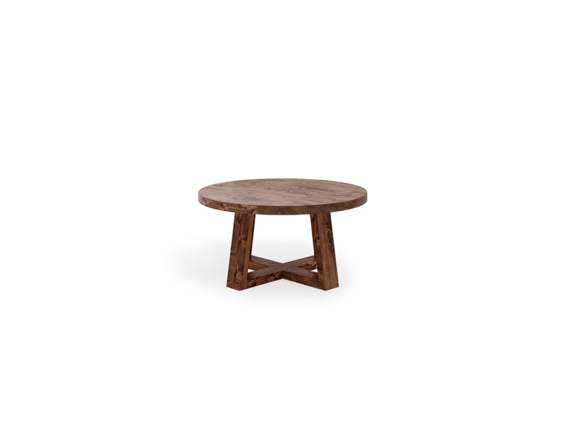 The Rae Coffee Table - Tuscany by James+James is a round wooden table featuring a cross-shaped base.