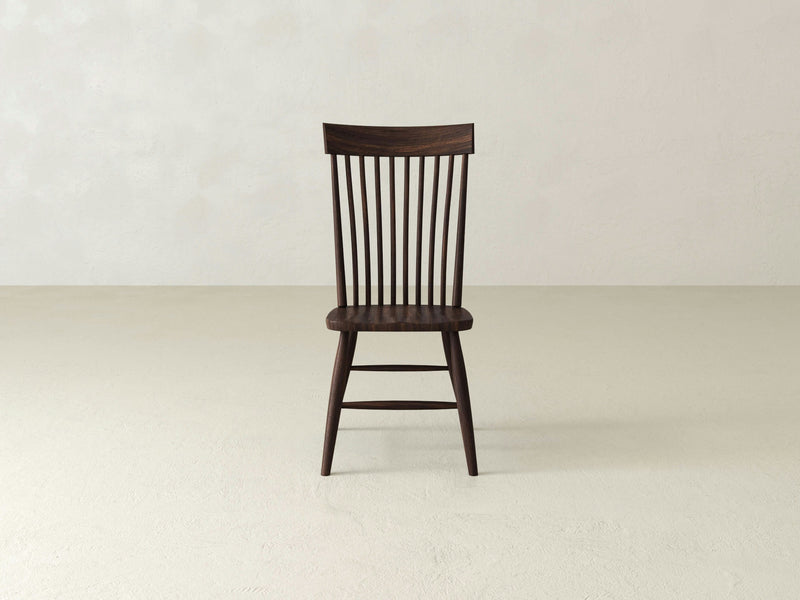 The Eleanor Side Dining Chair - Tobacco from James+James, features a high back with vertical slats and simple, straight legs in a dark brown finish. The chair is centered against a plain, light-colored background.