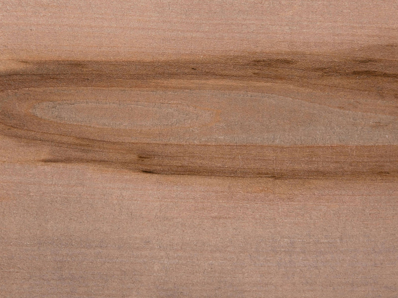 A close-up view of the Barn Wood on Maple Sample by James+James displays the natural grain patterns in various shades of light and dark brown. The texture appears smooth, with a combination of straight and wavy lines running across the image.