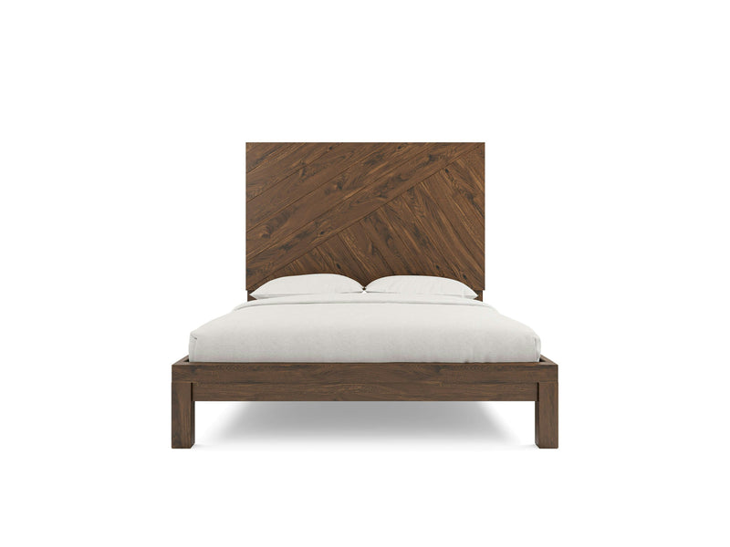 A stylish bed frame in deep grey named Luna by James+James, showcasing a tall, rectangular headboard with a distinctive diagonal plank design. The bed is accompanied by a white mattress, white bed linens, and two pillows, all viewed from the front. The overall design exudes simplicity and modern elegance.