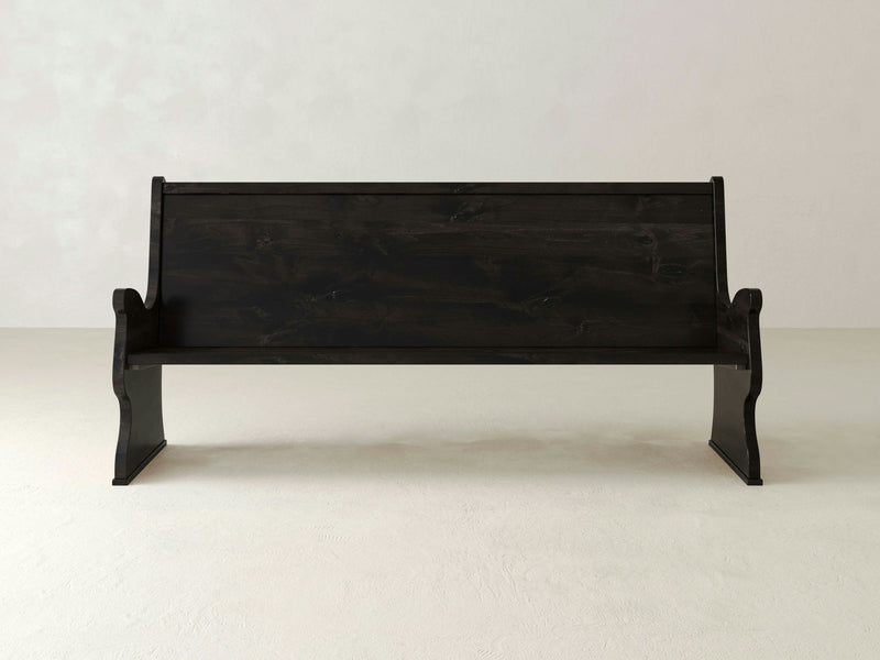 A close-up of the dark, textured surface of the Rustic Church Pew Bench - Charred Ember by James+James. The grain patterns and slight variations in color and texture are visible, adding depth and character to the bench.