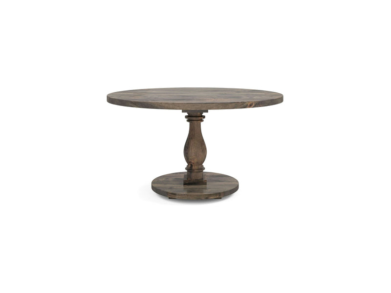 The Vivien Round Dining Table from James+James features a single central pedestal base. The tabletop has a deep grey wood finish, and the wooden pedestal is slightly ornate in design. The table stands on a circular, flat base.