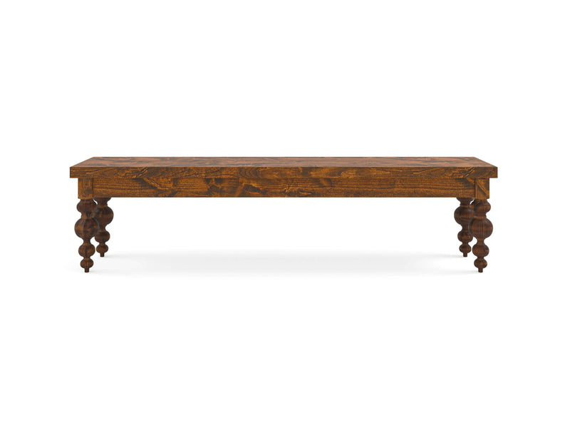 Introducing the Olivia Bench - Tuscany by James+James, a decorative wooden bench characterized by its flat rectangular seat and four intricately carved, spindle-style legs. Finished in a rich, dark brown hue with visible wood grain patterns, this piece offers a rustic yet elegant aesthetic. The bench is displayed against a plain white background to highlight its exquisite features.