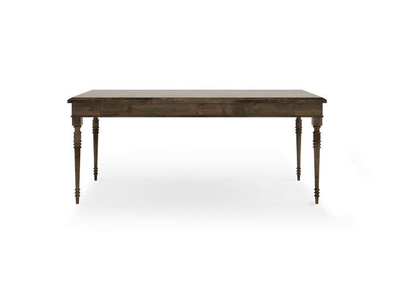 The Audrey Desk - Deep Grey by James+James is a rectangular wooden desk with a deep grey finish and four intricately carved legs. The desk features a simple, classic design with a smooth top and slightly tapered legs. The background is white, highlighting the details of the desk.