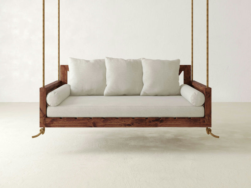 A wooden Avery Porch Swing - Tuscany with gold handles by James+James.