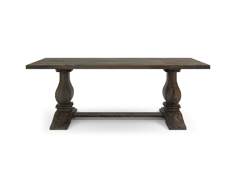 Presenting the Heirloom Dining Table - Deep Grey by James+James, this elegant piece flaunts a dark wooden finish with a rectangular tabletop that exudes a classic, rustic design. It boasts two prominent pedestal legs adorned with intricate carvings, connected by a horizontal support beam at the base. The table showcases a robust and sturdy appearance perfect for any dining room setting.