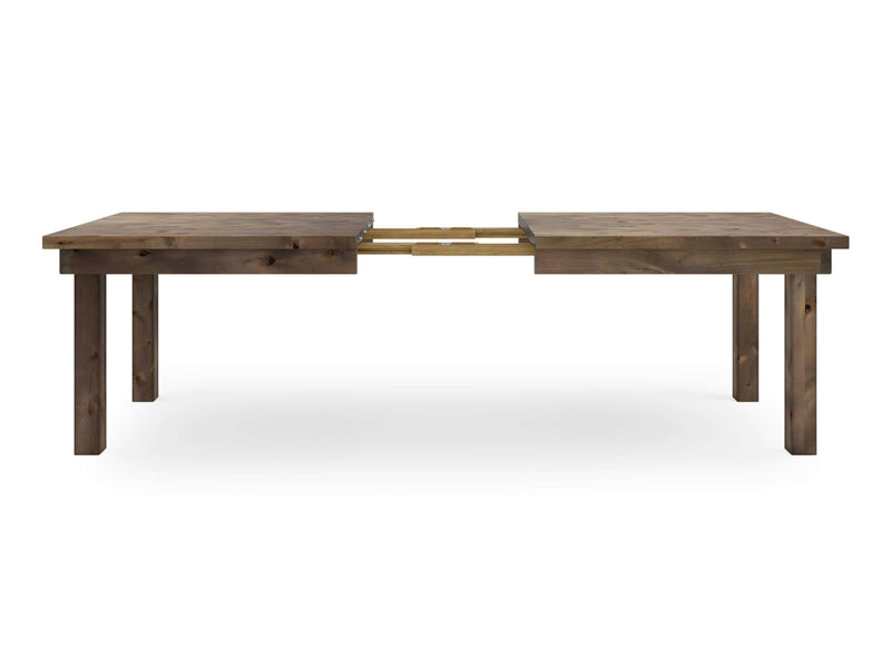 The Farmhouse Expandable Dining Table - Barn Wood by James+James, showcased in its extended form, features a rustic finish with square legs and an exposed section revealing the extension mechanism. Its simple and robust design makes it suitable for various decor styles.